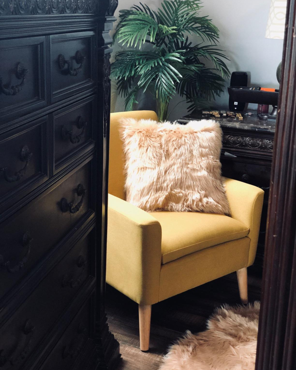 Mustard accent chair styled in a cozy living room