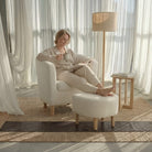 The female model sat in the Sherpa accent chair