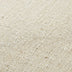 Macro close-up of the oatmeal linen upholstery texture on the swivel accent chair.