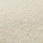 Macro close-up of the oatmeal linen upholstery texture on the swivel accent chair.